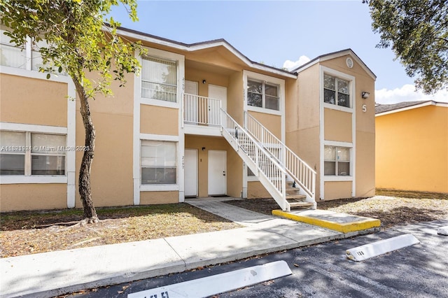 2203 SW 80th Ter Unit 2203, Miramar, FL 33025 - view of building exterior featuring stairway and uncovered parking