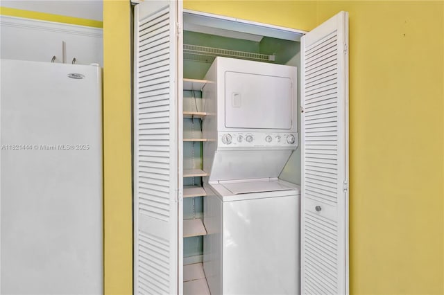1798 Maplewood Trl, Coconut Creek, FL 33063 - laundry area featuring stacked washing machine and dryer and tile patterned floors