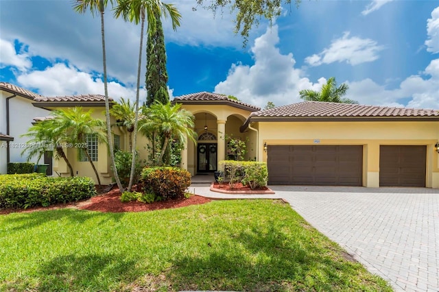 1925 NW 167th Ter, Pembroke Pines, FL 33028 - mediterranean / spanish home featuring stucco siding, an attached garage, a front yard, decorative driveway, and a tile roof