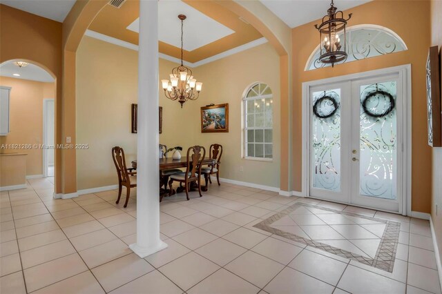 1925 NW 167th Ter, Pembroke Pines, FL 33028 - entryway featuring a chandelier, french doors, arched walkways, light tile patterned flooring, and crown molding