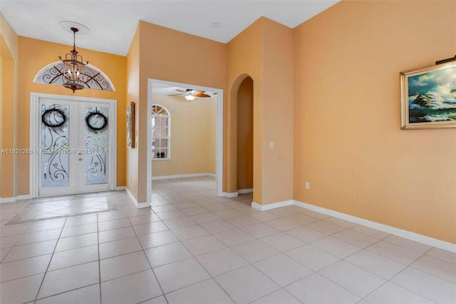 1925 NW 167th Ter, Pembroke Pines, FL 33028 - foyer entrance with arched walkways, a chandelier, light tile patterned floors, and french doors