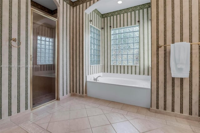 1925 NW 167th Ter, Pembroke Pines, FL 33028 - bathroom featuring wallpapered walls, a garden tub, healthy amount of natural light, and tile patterned flooring