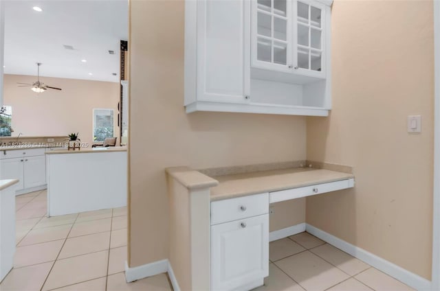 1925 NW 167th Ter, Pembroke Pines, FL 33028 - kitchen with built in study area, white cabinetry, light tile patterned floors, ceiling fan, and light countertops