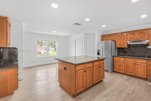 14821 SW 148th St Cir, Miami, FL 33196 - kitchen with stainless steel refrigerator with ice dispenser, under cabinet range hood, light wood-type flooring, decorative backsplash, and black electric cooktop