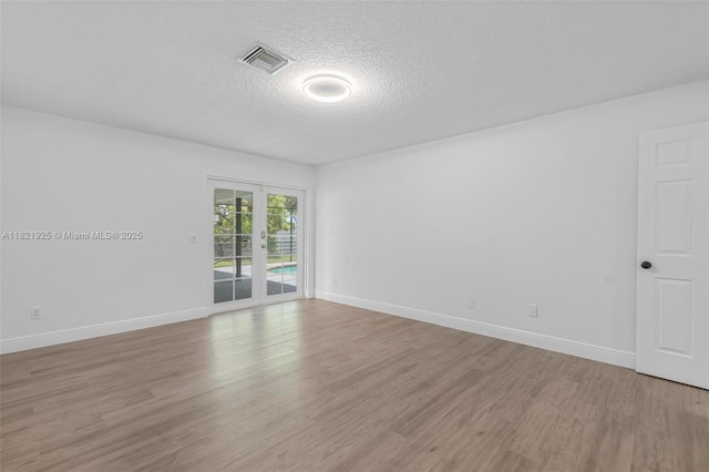 14821 SW 148th St Cir, Miami, FL 33196 - spare room featuring a textured ceiling and light wood-style floors