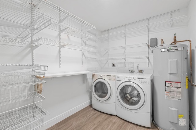 14821 SW 148th St Cir, Miami, FL 33196 - laundry room featuring electric water heater, washing machine and clothes dryer, and light wood-style floors