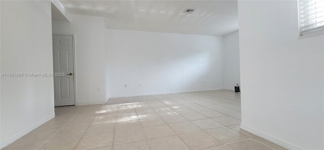 975 NE 42nd Pl, Homestead, FL 33033 - spare room with light tile patterned flooring and a textured ceiling