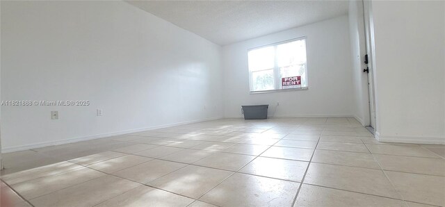 975 NE 42nd Pl, Homestead, FL 33033 - spare room with light tile patterned flooring and lofted ceiling
