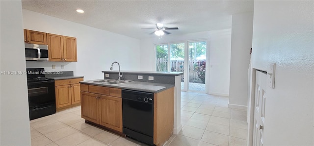 975 NE 42nd Pl, Homestead, FL 33033 - kitchen featuring black appliances, ceiling fan, light tile patterned floors, dark countertops, and a textured ceiling