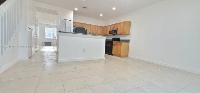 975 NE 42nd Pl, Homestead, FL 33033 - kitchen featuring stainless steel microwave, stove, fridge, recessed lighting, and light tile patterned floors