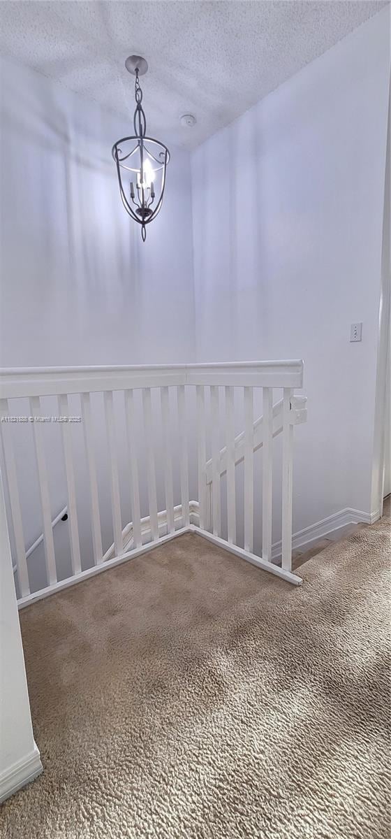 975 NE 42nd Pl, Homestead, FL 33033 - carpeted spare room with a textured ceiling and a chandelier