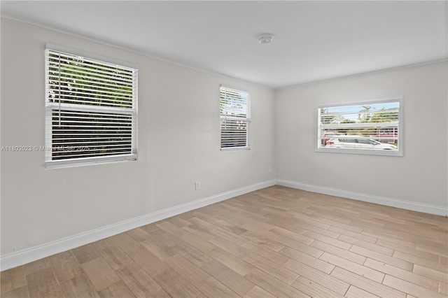 421 SW 64th Ter, Margate, FL 33068 - empty room with healthy amount of natural light, light wood-type flooring, a smoke detector, and ornamental molding