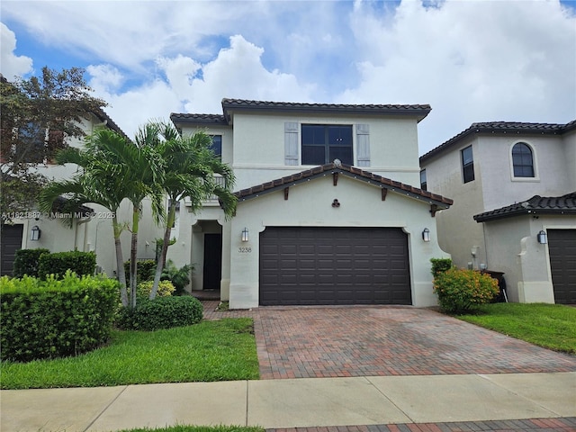3238 W 96th Pl, Hialeah, FL 33018 - mediterranean / spanish-style home featuring decorative driveway, a tiled roof, stucco siding, and a garage