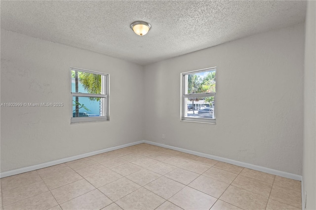 5288 N Andrews Ave, Oakland Park, FL 33309 - empty room featuring healthy amount of natural light, a textured ceiling, and light tile patterned floors
