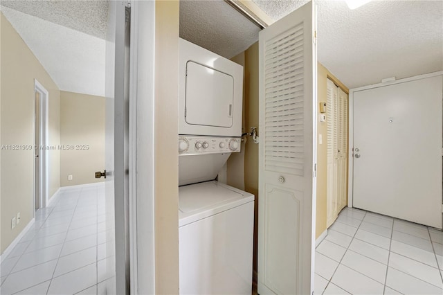 8305 NW 61st St Unit C305, Tamarac, FL 33321 - laundry area featuring estacked washer and dryer, light tile patterned floors, and a textured ceiling