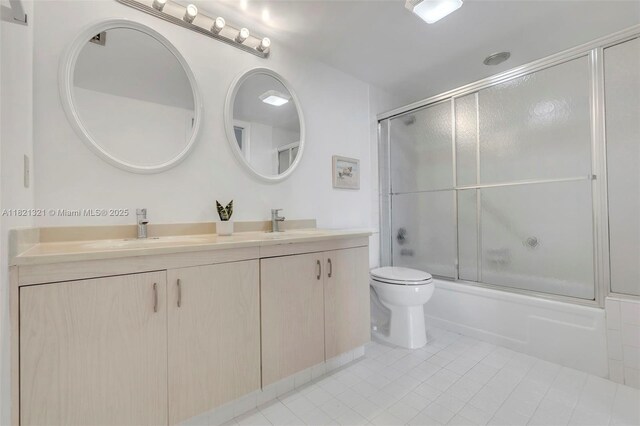 2504 Antigua Ter Unit L4, Coconut Creek, FL 33066 - bathroom featuring double vanity, tile patterned flooring, and combined bath / shower with glass door
