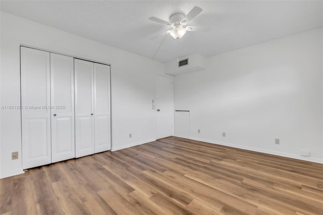2504 Antigua Ter Unit L4, Coconut Creek, FL 33066 - unfurnished bedroom featuring wood finished floors, a closet, and a ceiling fan