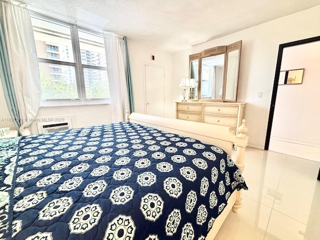 1936 S Ocean Dr Unit 7C, Hallandale Beach, FL 33009 - tiled bedroom featuring a textured ceiling and a wall mounted AC