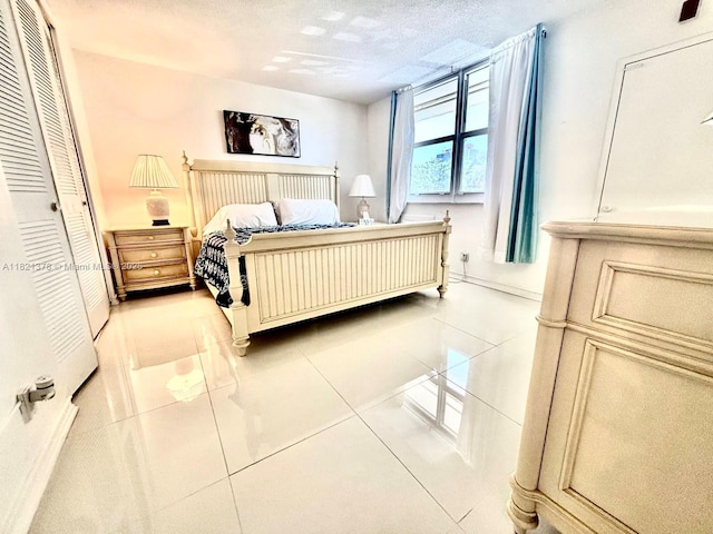 1936 S Ocean Dr Unit 7C, Hallandale Beach, FL 33009 - bedroom with tile patterned flooring and a textured ceiling