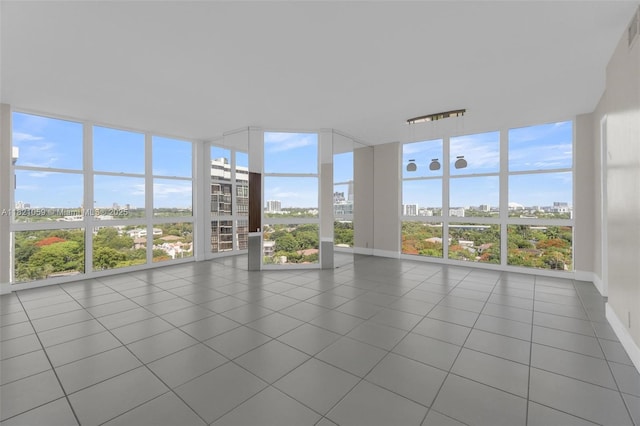 1901 Brickell Ave Unit B1508, Miami, FL 33129 - unfurnished sunroom featuring floor to ceiling windows, a city view, and tile patterned flooring