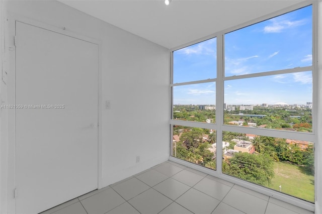 1901 Brickell Ave Unit B1508, Miami, FL 33129 - unfurnished room with light tile patterned flooring, a view of city, and a wall of windows