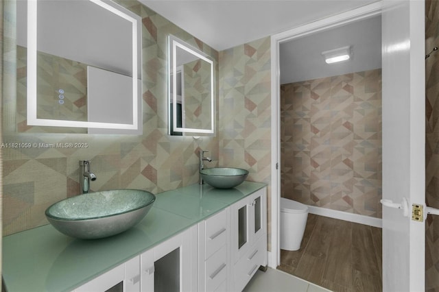 1901 Brickell Ave Unit B1508, Miami, FL 33129 - full bathroom featuring double vanity, wood finished floors, and backsplash