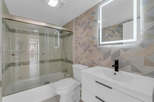 1901 Brickell Ave Unit B1508, Miami, FL 33129 - full bathroom featuring tile walls, combined bath / shower with glass door, and vanity