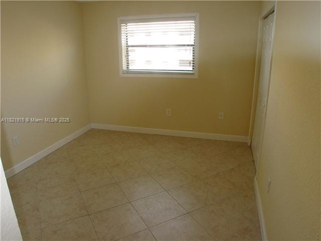 8185 NW 7th St Unit 316, Miami, FL 33126 - unfurnished room with baseboards and light tile patterned flooring