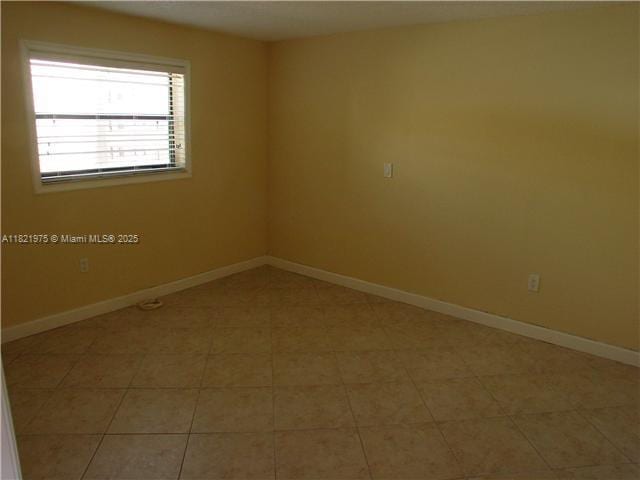 8185 NW 7th St Unit 316, Miami, FL 33126 - empty room featuring baseboards and light tile patterned floors