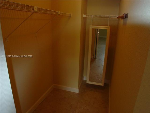 8185 NW 7th St Unit 316, Miami, FL 33126 - walk in closet with tile patterned flooring