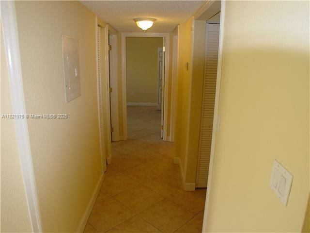 8185 NW 7th St Unit 316, Miami, FL 33126 - hall featuring electric panel and light tile patterned floors