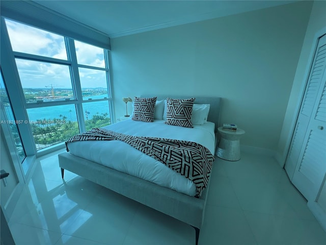 300 S Pointe Dr Unit 1602, Miami Beach, FL 33139 - bedroom featuring tile patterned flooring, a water view, and ornamental molding