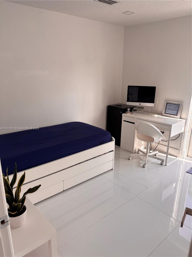 12923 SW 207th Ter, Miami, FL 33177 - bedroom featuring a textured ceiling and a desk