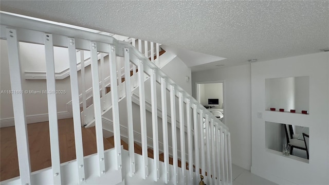 12923 SW 207th Ter, Miami, FL 33177 - staircase with a textured ceiling