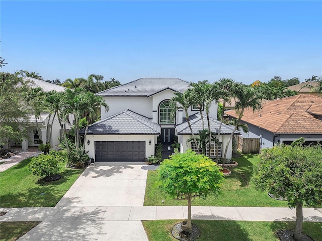 16132 SW 147th Ln, Miami, FL 33196 - mediterranean / spanish house with stucco siding, a garage, a tiled roof, and concrete driveway