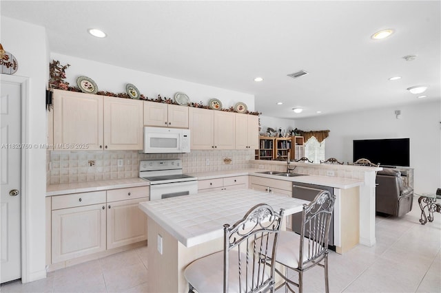 16132 SW 147th Ln, Miami, FL 33196 - kitchen with white appliances, a peninsula, backsplash, open floor plan, and recessed lighting