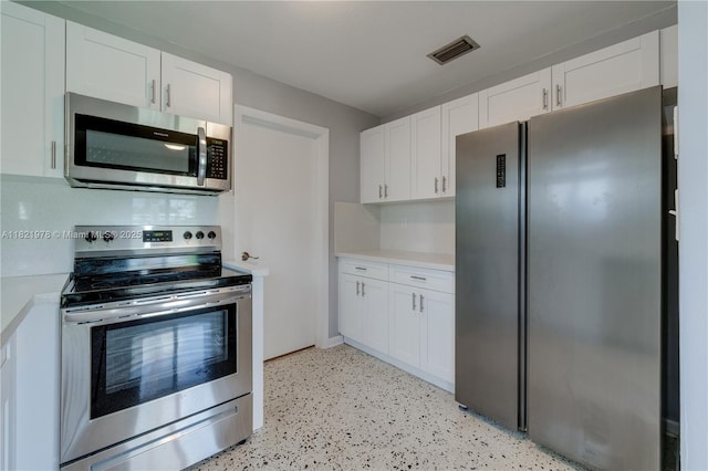 3731 SW 88th Pl, Miami, FL 33165 - kitchen with appliances with stainless steel finishes, light countertops, and white cabinets