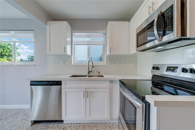 3731 SW 88th Pl, Miami, FL 33165 - kitchen with stainless steel appliances, plenty of natural light, and white cabinetry