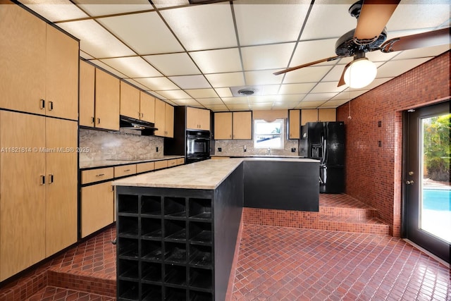 5025 SW 90th Ct, Miami, FL 33165 - kitchen featuring black appliances, under cabinet range hood, light countertops, a center island, and brick wall