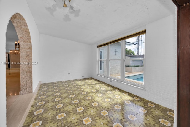 5025 SW 90th Ct, Miami, FL 33165 - empty room featuring arched walkways and brick wall