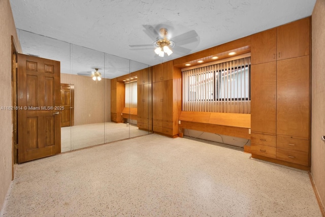5025 SW 90th Ct, Miami, FL 33165 - empty room featuring a ceiling fan, speckle patterned floor, and wooden walls