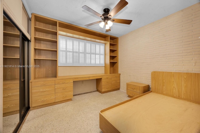 5025 SW 90th Ct, Miami, FL 33165 - unfurnished bedroom with brick wall, built in desk, and a ceiling fan