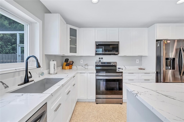 6736 Orchid Dr, Miami Lakes, FL 33014 - kitchen featuring stainless steel appliances, white cabinetry, light stone countertops, and glass insert cabinets