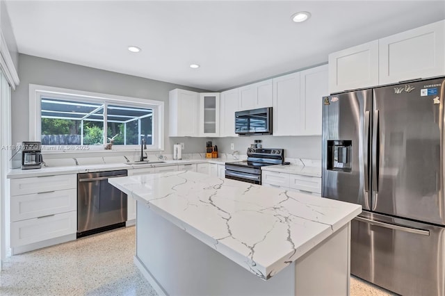 6736 Orchid Dr, Miami Lakes, FL 33014 - kitchen with stainless steel appliances, dark speckled floor, light stone countertops, glass insert cabinets, and recessed lighting