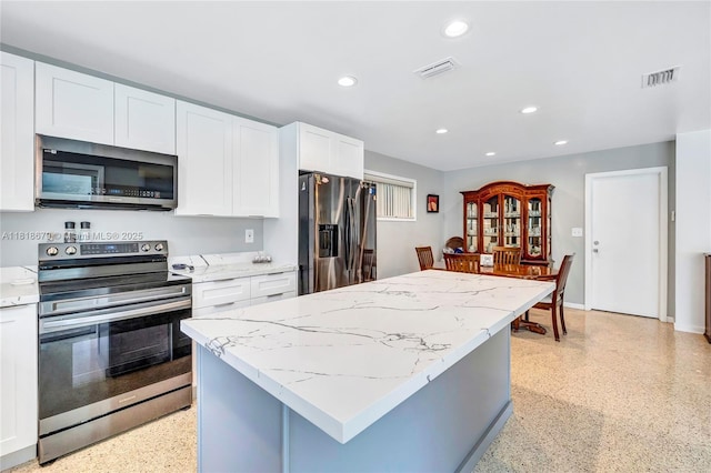 6736 Orchid Dr, Miami Lakes, FL 33014 - kitchen with appliances with stainless steel finishes, recessed lighting, white cabinetry, a center island, and dark aggregate flooring