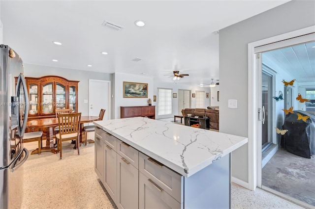 6736 Orchid Dr, Miami Lakes, FL 33014 - kitchen featuring stainless steel refrigerator with ice dispenser, light stone countertops, gray cabinets, a kitchen island, and recessed lighting