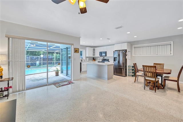 6736 Orchid Dr, Miami Lakes, FL 33014 - living area with a sunroom, a ceiling fan, dark aggregate flooring, and recessed lighting