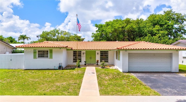 6736 Orchid Dr, Miami Lakes, FL 33014 - view of front of home with stucco siding, a garage, asphalt driveway, and a tiled roof