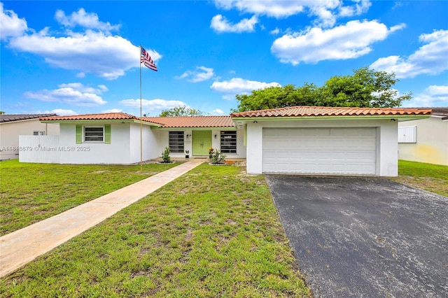 6736 Orchid Dr, Miami Lakes, FL 33014 - view of front facade with stucco siding, driveway, a garage, and a front lawn