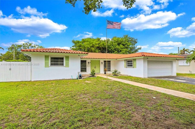 6736 Orchid Dr, Miami Lakes, FL 33014 - view of front of property with an attached garage, stucco siding, asphalt driveway, and a tile roof